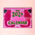 Cat calendar wall planner showing daily tear-off sheets with feline imagery