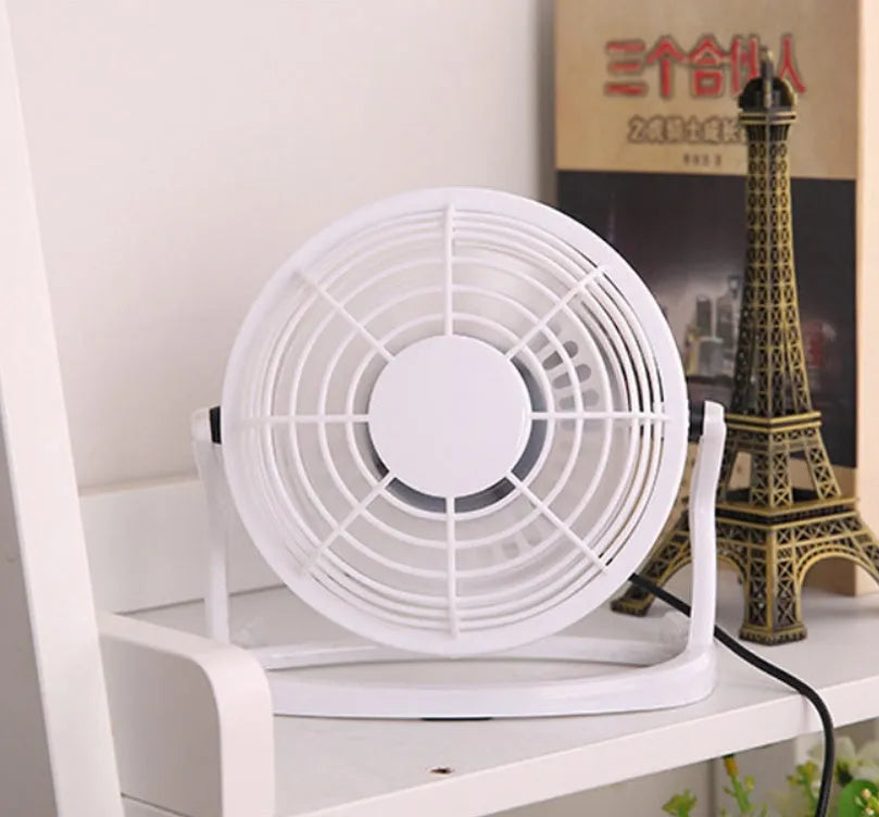 Mini adjustable USB desk fan in black, showing compact square design and angled breeze outlet