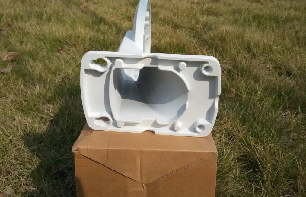 White aluminium alloy and ABS dome camera wall mount bracket on a white wall