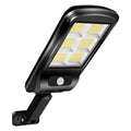Black solar-powered outdoor motion sensor light mounted on a wall.