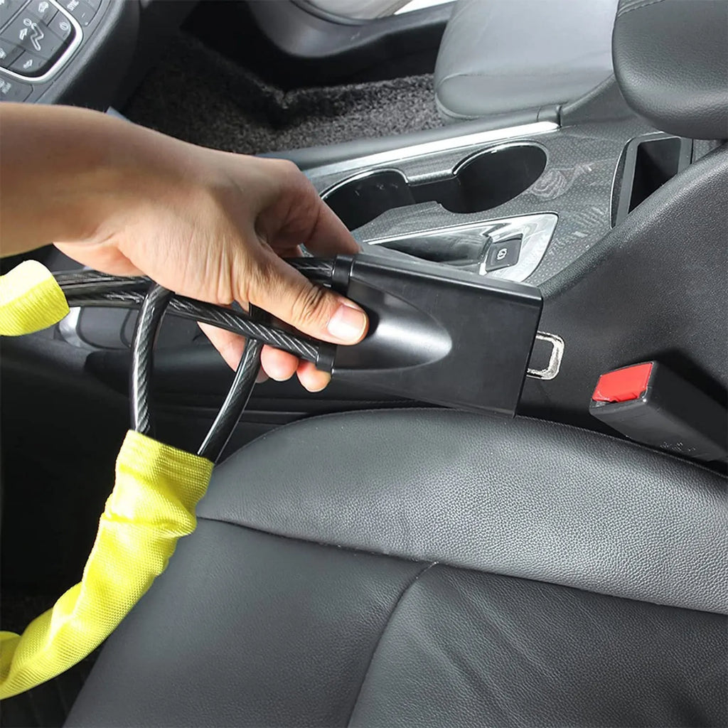 Red iron cable car steering wheel lock for General Motors vehicles on a black steering wheel.
