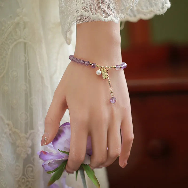 Natural crystal lavender amethyst bracelet for women in dark and light colour variations on a wrist.