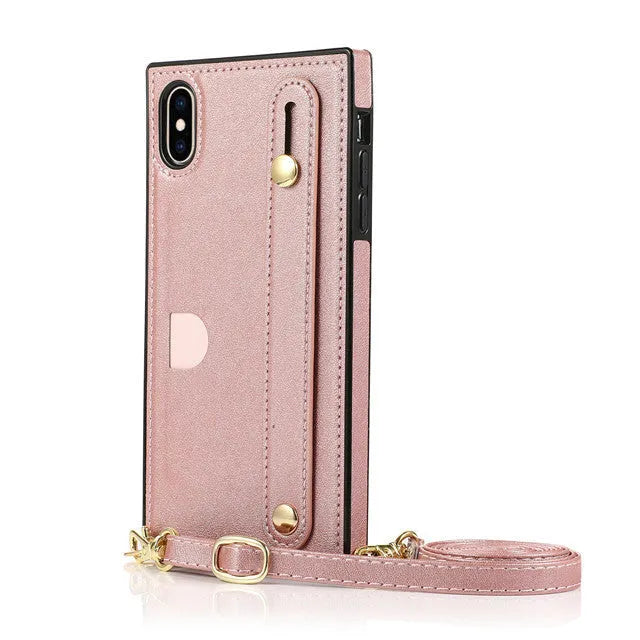 Leather iPhone case with card slots on the back and an attached black wrist strap.