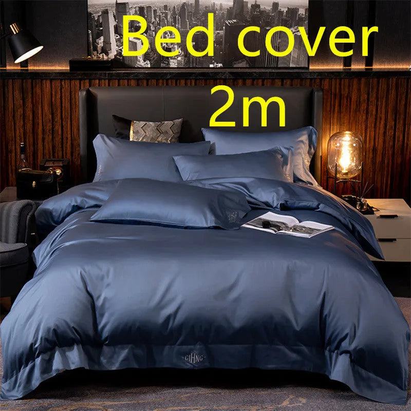 Four-piece cotton satin quilted bedding set with duvet cover, sheet, and pillowcases in a bedroom setting