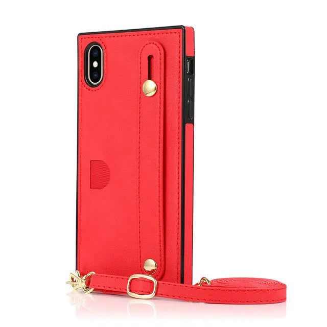 Leather iPhone case with card slots on the back and an attached black wrist strap.