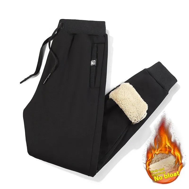 Men's grey fleece-lined cotton track pants with an elasticated waistband and drawstring, shown in an oversized fit.