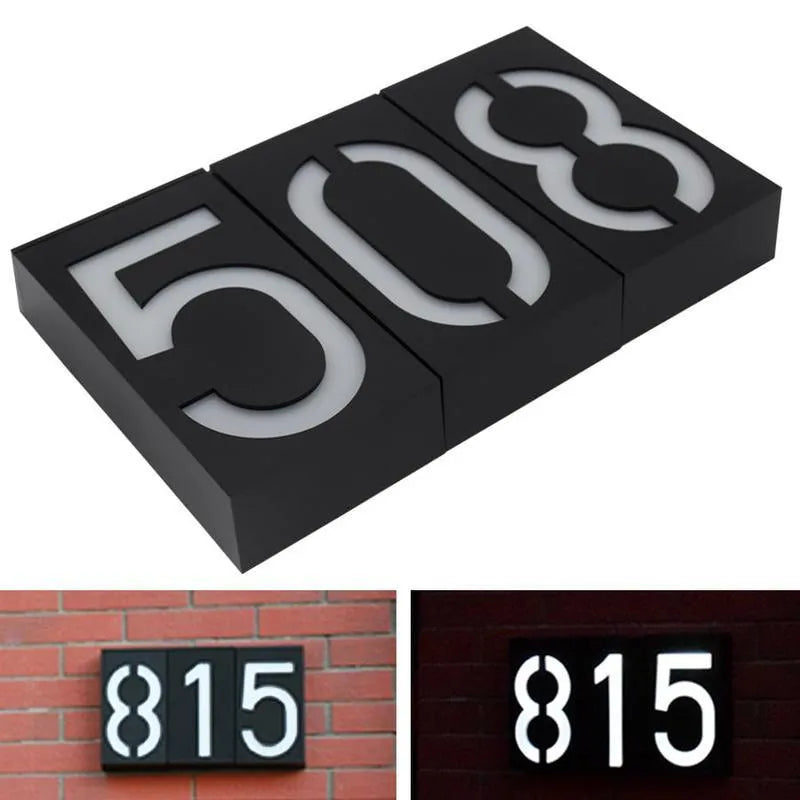 Solar powered white LED house number light with IP65 waterproof rating mounted on a wall.