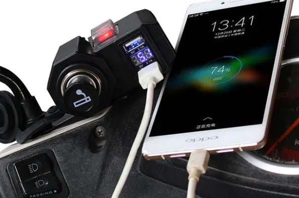 Black dual USB waterproof motorcycle charger with voltmeter and cigarette lighter mounted on handlebar