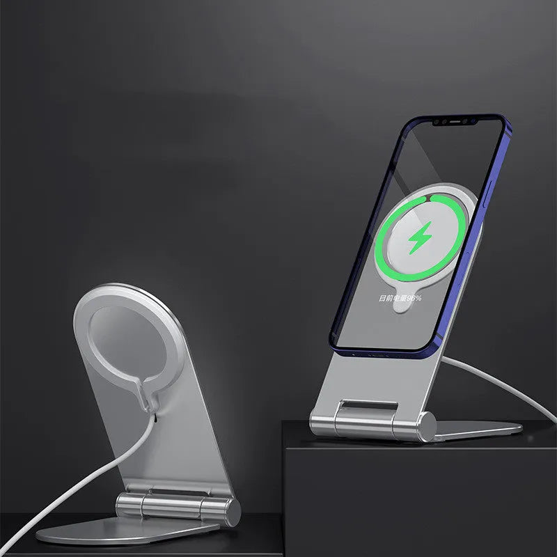 Silver vertical aluminium alloy magnetic phone bracket for iPhone 12 on a table.