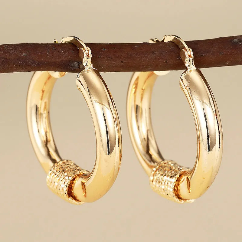 Geometric copper earrings in golden colours with ring and line elements for women