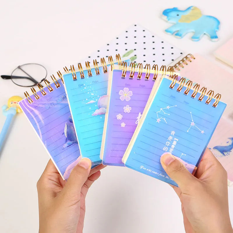 Rollover coil spiral bound pocket notepad with PP cover in Constellation design, shown open and laying flat.