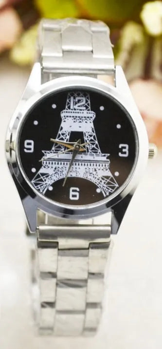 Black leather strap watch with an Eiffel Tower model on the case and an analogue dial