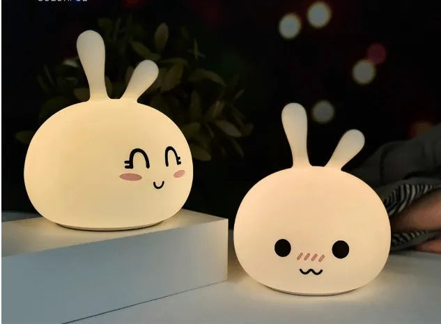 Marshmallow Bunny LED Night Light with 0.4W ABS silicone construction and happy face expression on a bedside table