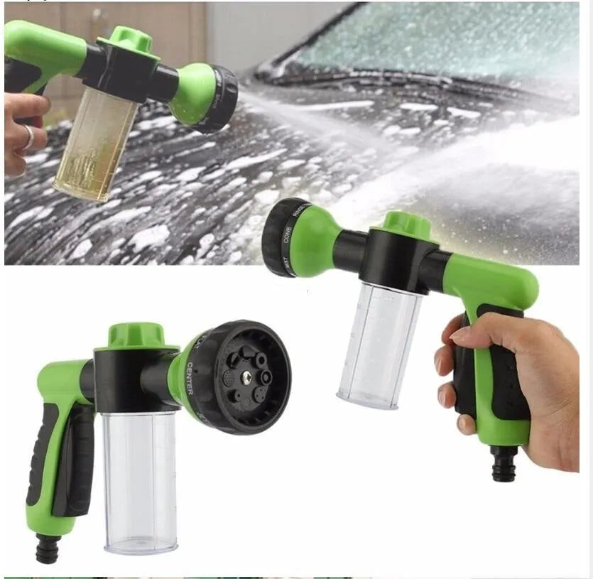Green high-pressure foam spray gun with adjustable nozzle and attached water pipe for car and garden cleaning.