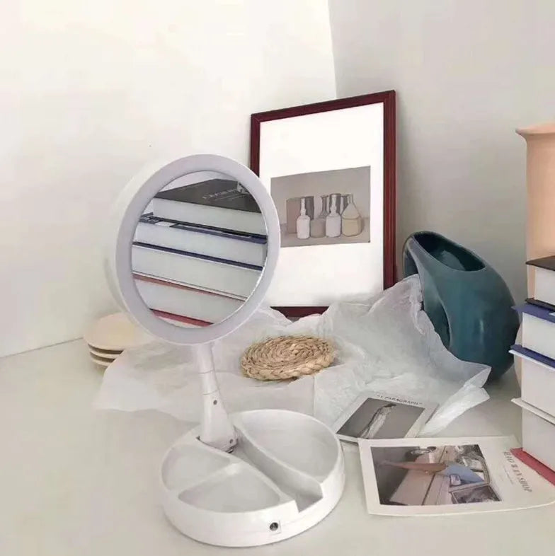 White foldable LED vanity mirror with storage compartments and USB charging port