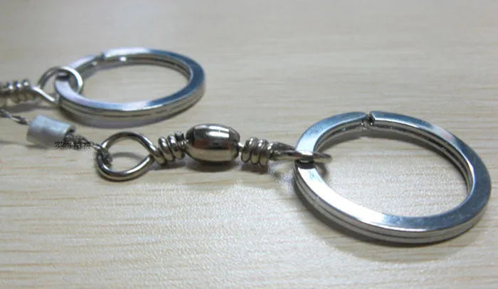 Stainless steel survival wire saw with thumb rings, showing extended length of 70cm.