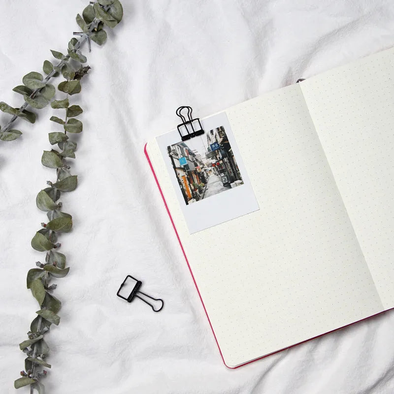 A5 dotted notebook with imitation leather cover in blue or pink colour options showing dot matrix interior pages