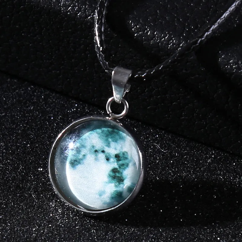 Luminous alloy necklace with a glass pendant depicting a Christmas moon night sky, showing the extension chain.