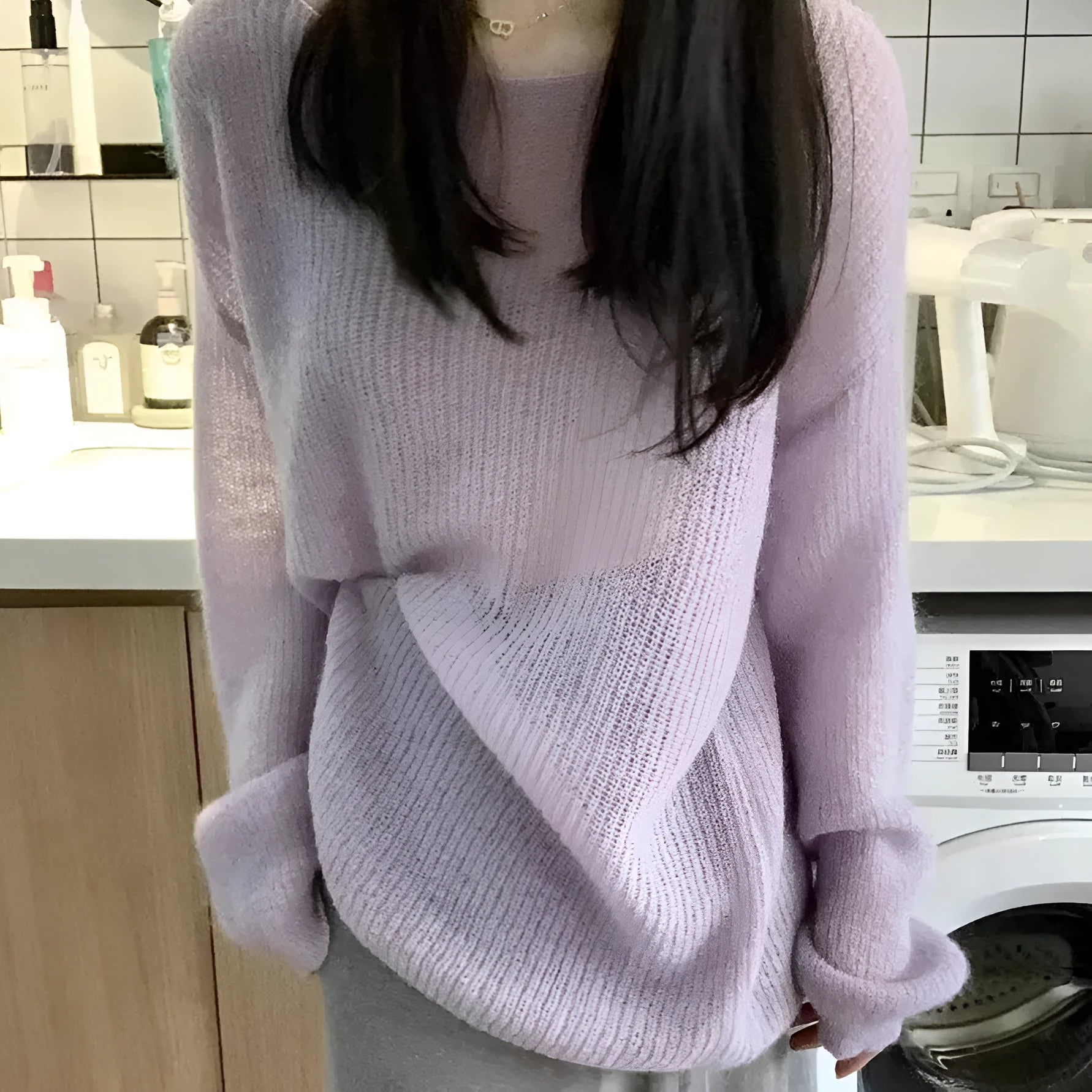 Purple women's blouse with hollow out design and sleeveless princess sleeves on a hanger.