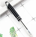 Red metal ballpoint pen with a capacitive stylus tip and built-in LED light on a desk.