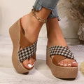 Leopard print plaid wedge sandals in brown and black with a rubber sole, shown in a casual setting.