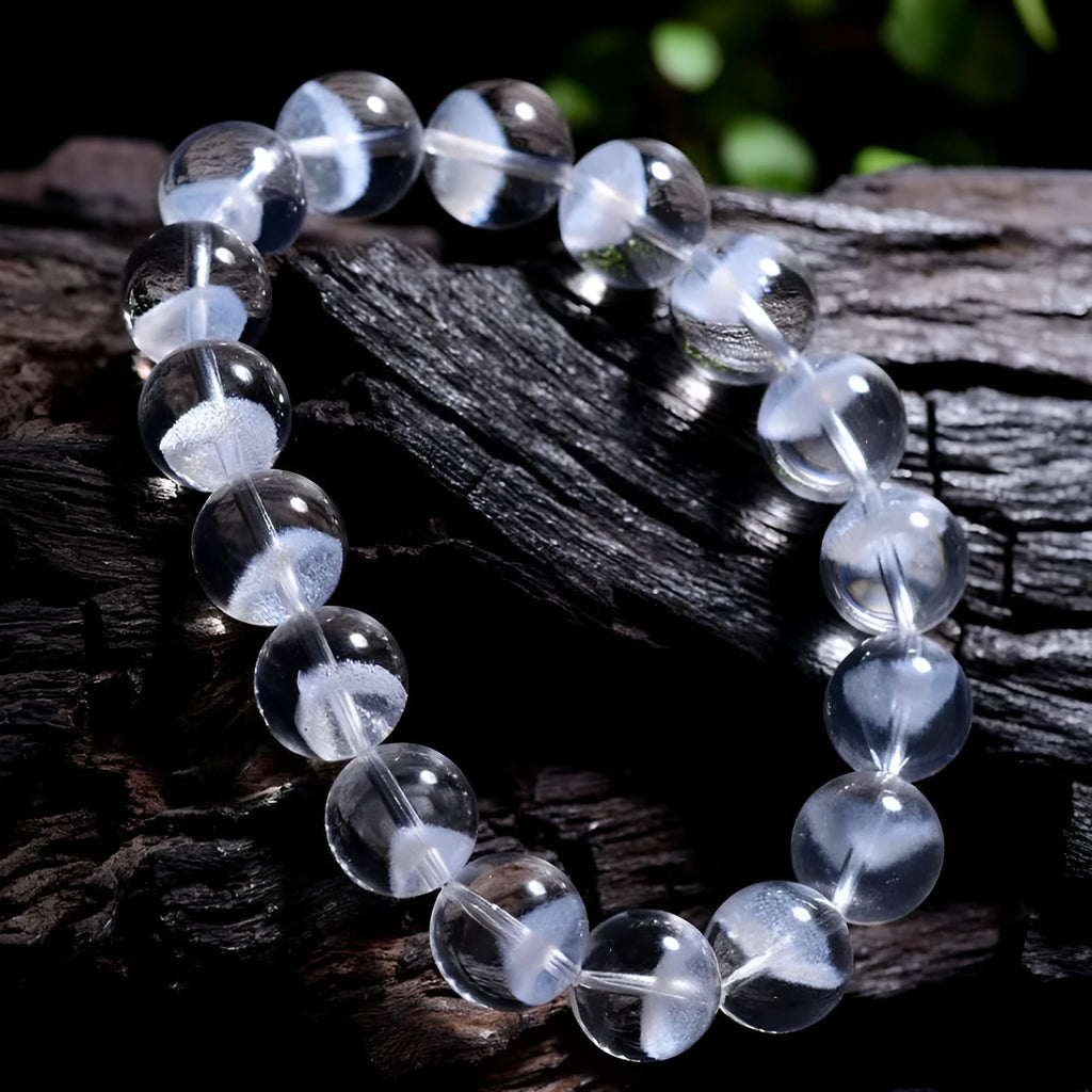 Women's adjustable white crystal ghost pyramid bracelet with Ruyi charm on wrist.