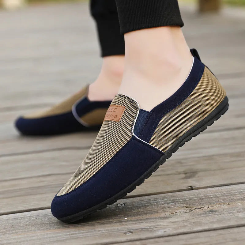 Men's grey canvas board shoes with round toe and rubber sole on a white background.