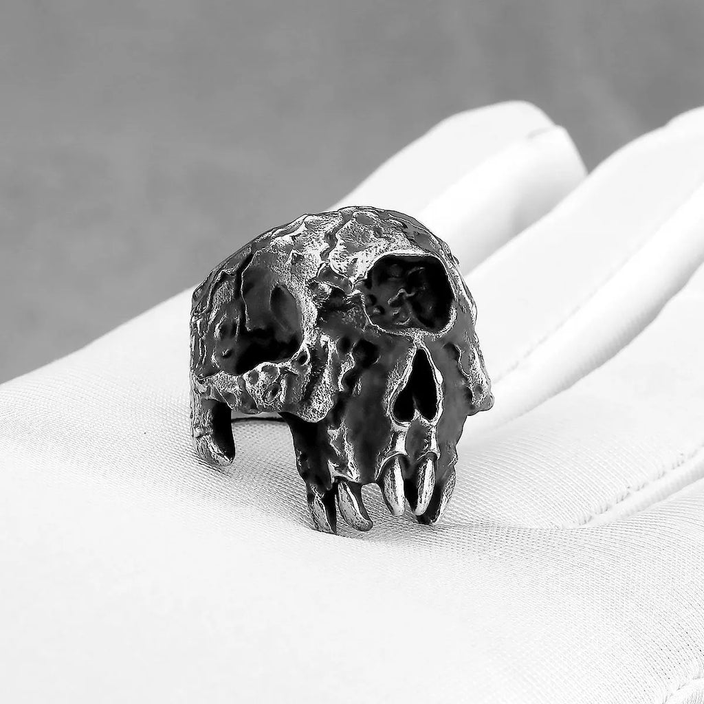Silver-coloured alloy ring with a detailed one-eyed skull design on a finger.