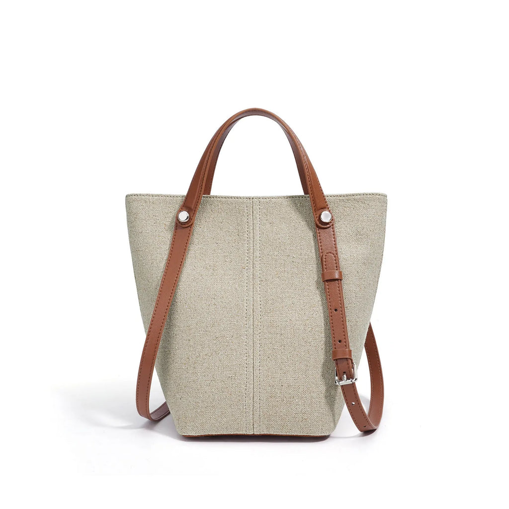Genuine leather bucket shoulder bag in Linen Black with stitching, open outer pocket, and hand-carry strap