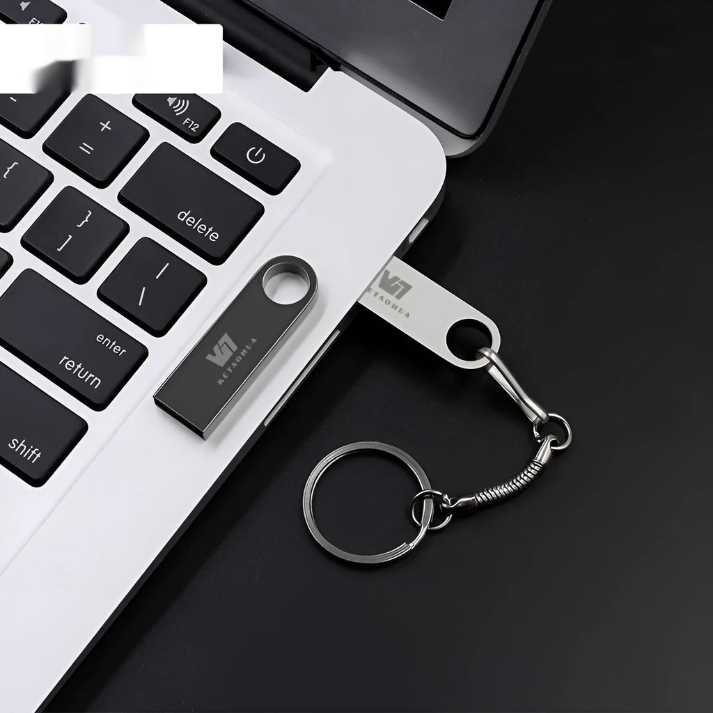 Silver metal car-shaped USB flash drive on a white background showing its compact size and design.