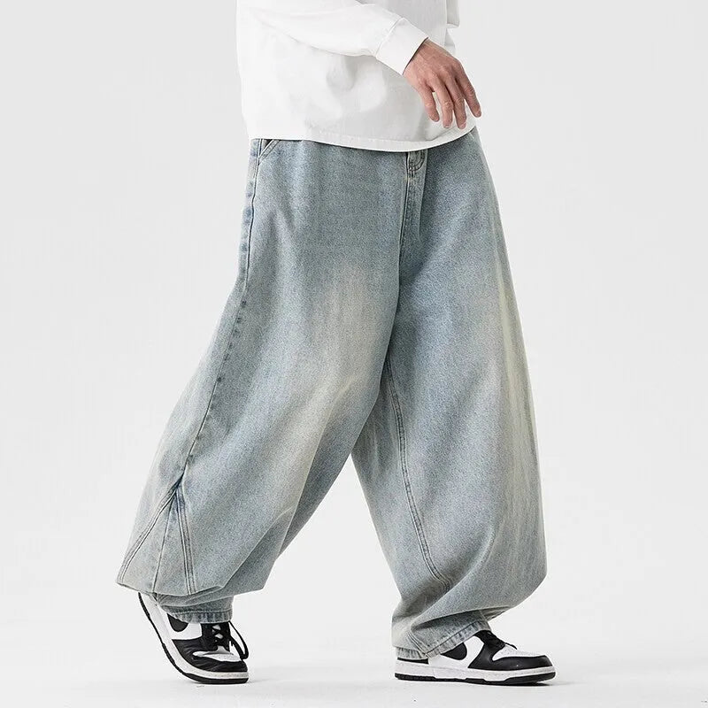 Man wearing plus size light blue wide leg baggy jeans, low waist straight leg casual style.