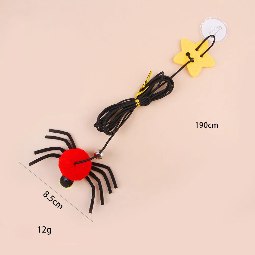 Red and yellow hanging door cat toy with feather, bell, spider, and elastic rope for interactive pet play