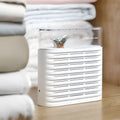 White recyclable cabinet dehumidifier box with transparent lid showing colour-changing silica gel beads.