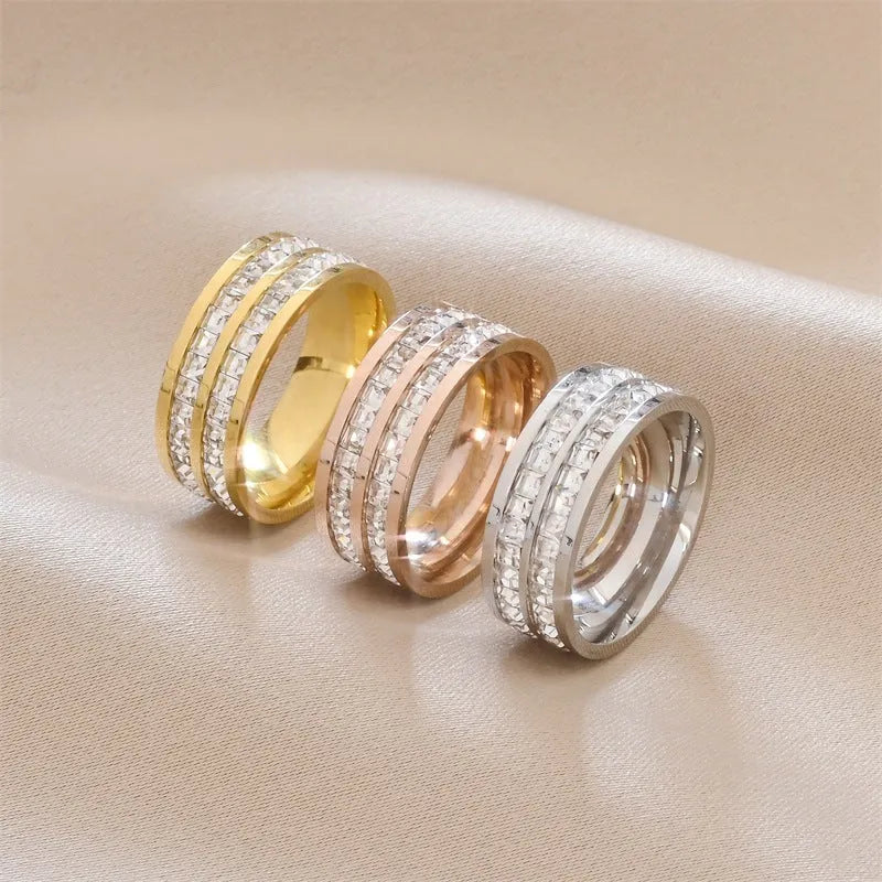 Stainless steel geometric star ring with zircon inlay in gold finish on white background
