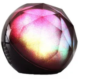 Compact LED seven-color Bluetooth speaker magic ball with colour-changing lights on a plain background