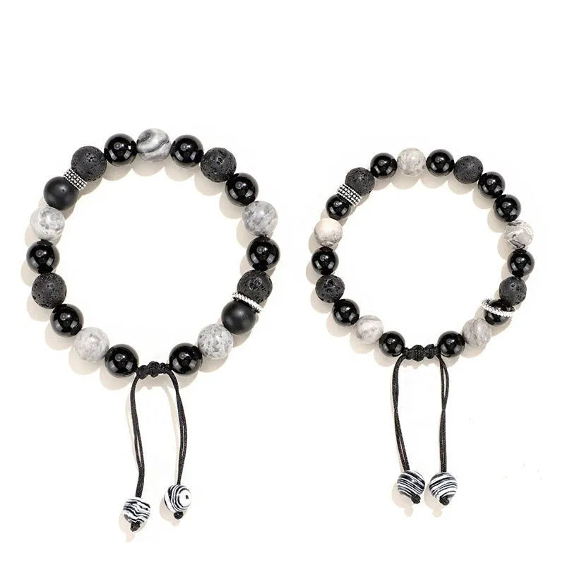 Black agate map stone volcanic rock bracelet with diamond-shaped cuts on wrist.