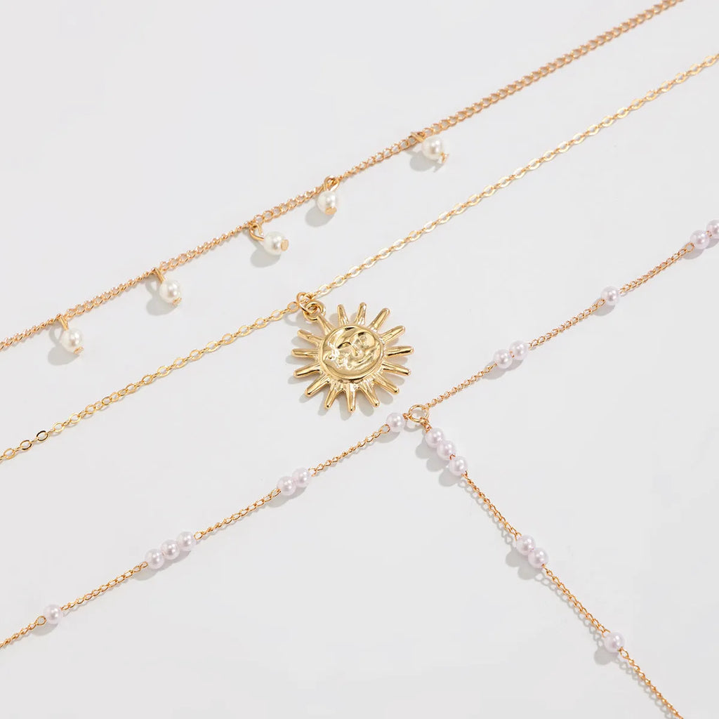Long Y-shaped twin necklace with tassel pendant in gold electroplated alloy with imitation pearl chain