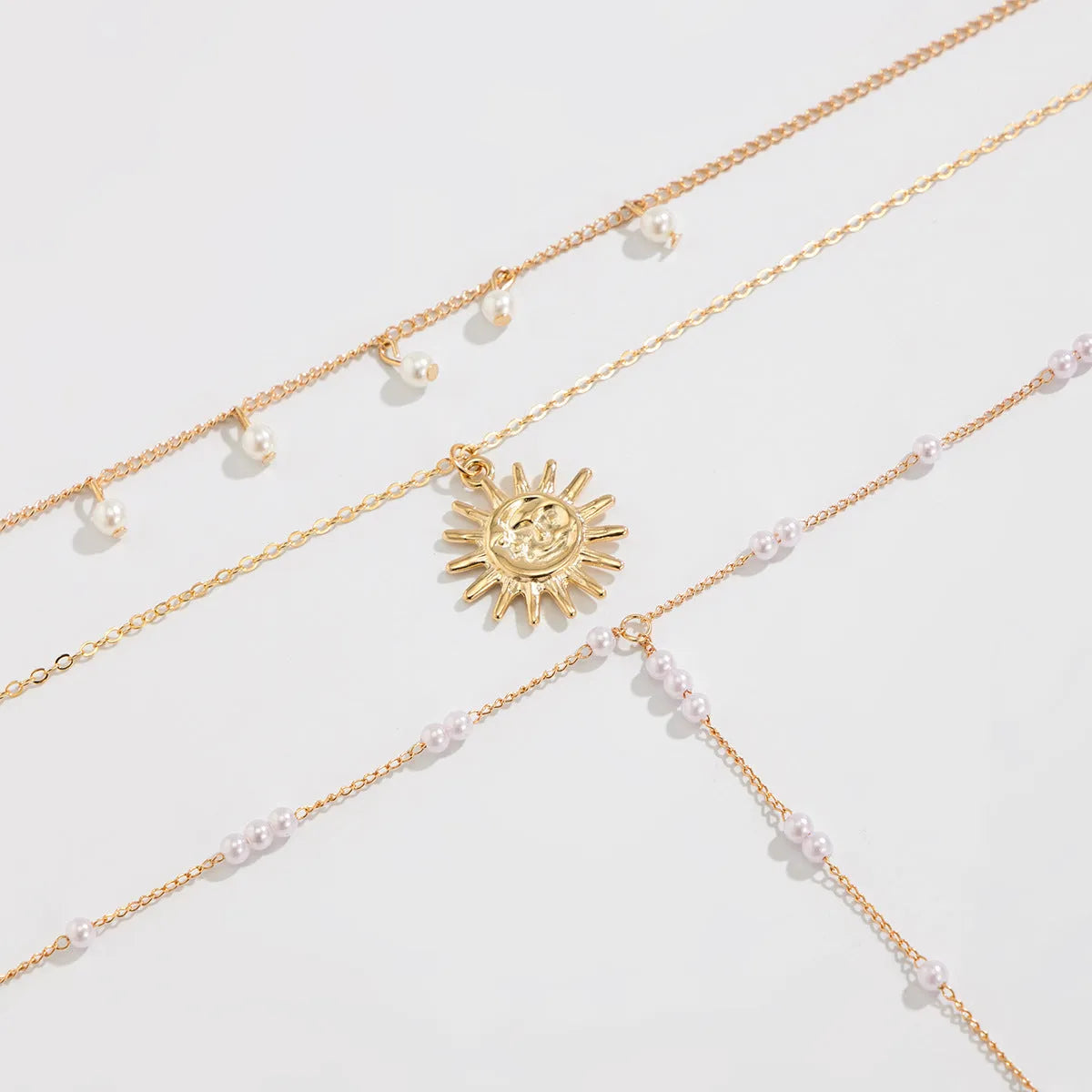Long Y-shaped twin necklace with tassel pendant in gold electroplated alloy with imitation pearl chain