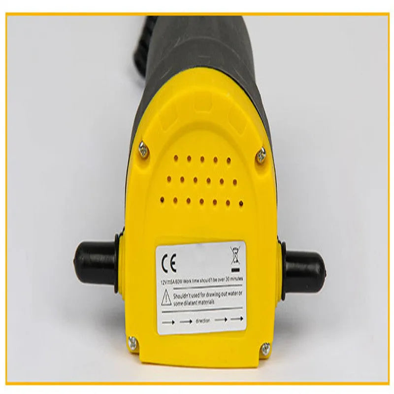 Yellow electric oil pump with cast aluminium body and 1.2m inlet pipe on a workshop bench