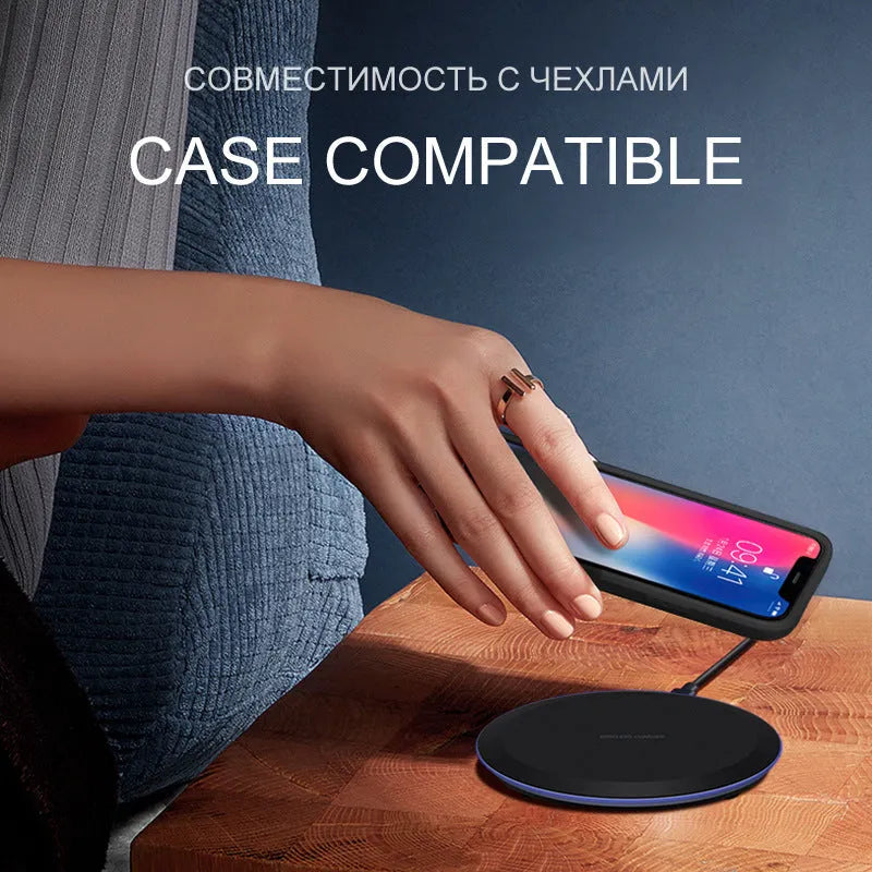 10W/5W black fast wireless phone charger pad on desk with iPhone - 100mm diameter, 8mm thick