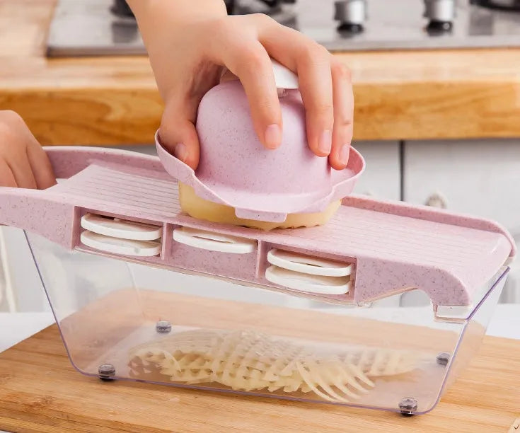 Multifunctional vegetable cutter with 7 stainless steel blades on a kitchen counter, compact 31.8 x 11.5 x 11.5 cm size