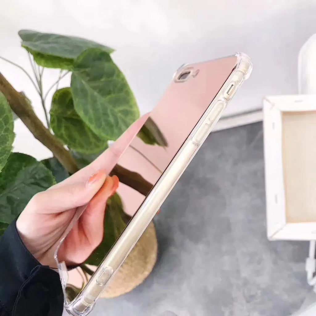 Mirrored front TPU protective case for iPhone in multiple colour options on a table.