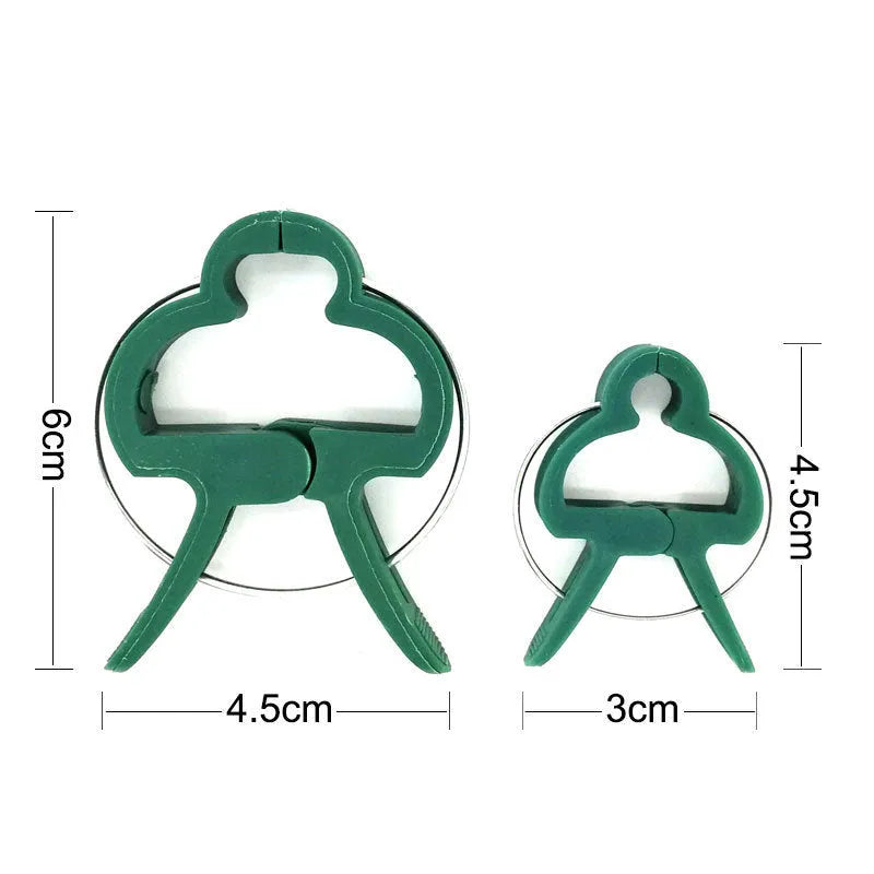 Green plastic and zinc plant fixing clips for supporting tomatoes, cucumbers, and climbing vines.