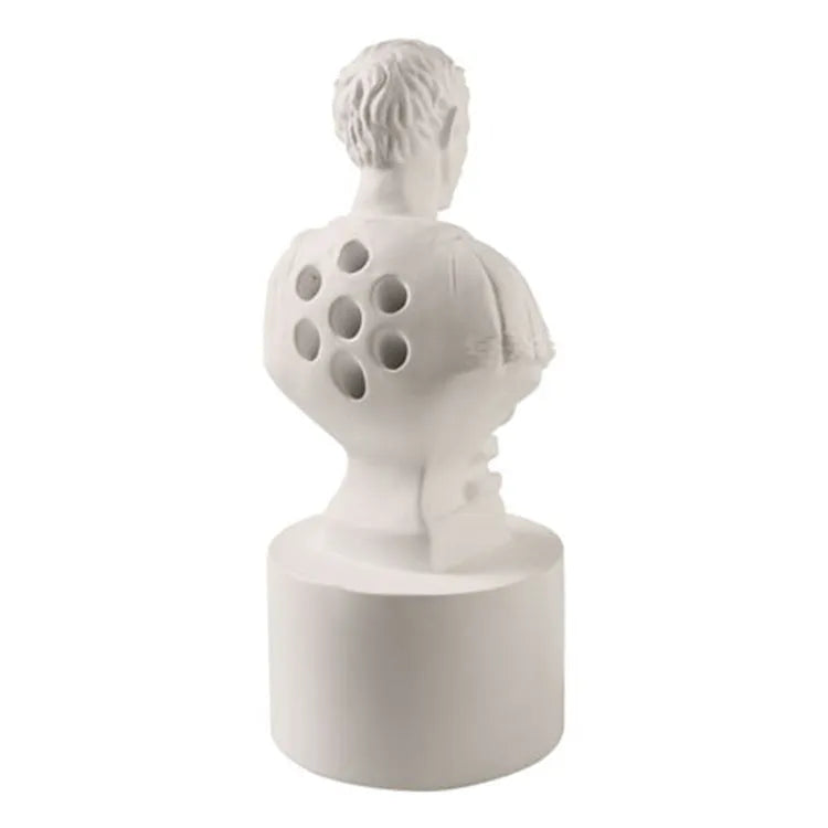 White synthetic resin pen holder with American cartoon character modelling on a desk.