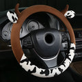 Plush car steering wheel cover in black and coffee colours showing protective handle feature