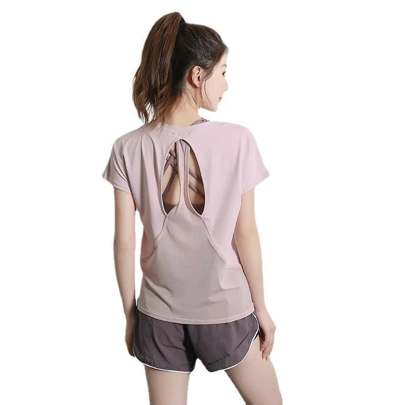 Ladies short sleeve polyester sports T-shirt in pink, shown on a hanger.