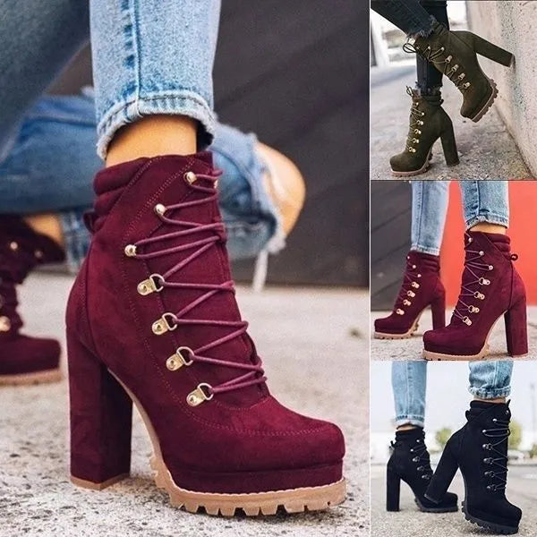 Women's suede high heel ankle boots with thick block heel in army green, showing round toe and belt buckle detail.