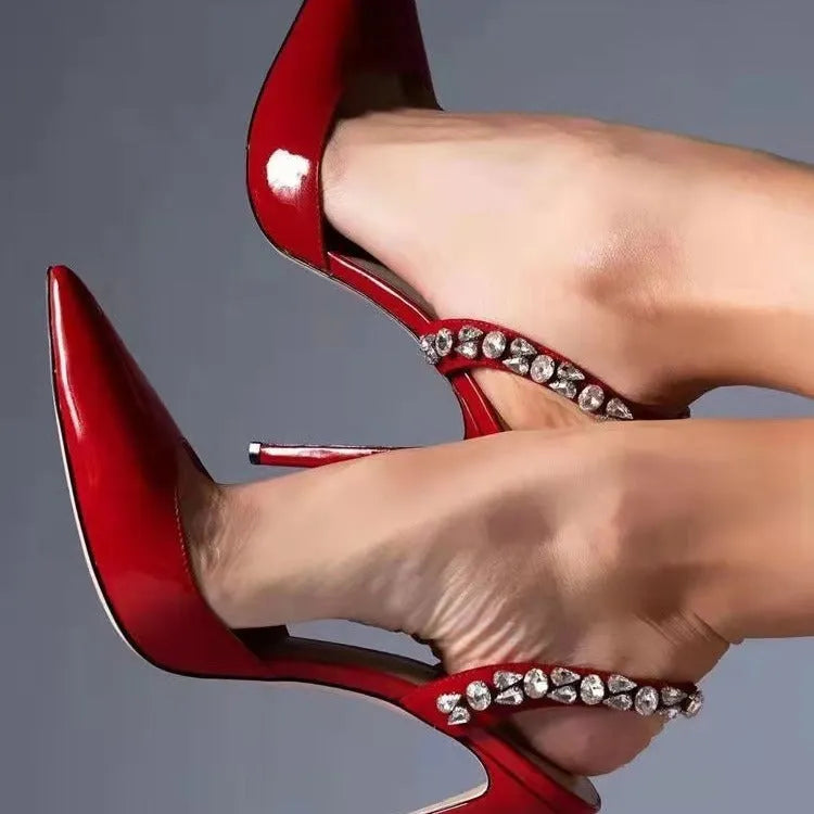 Women's black patent leather pointed toe high heel sandals with rhinestone side detail, shown on a white background.