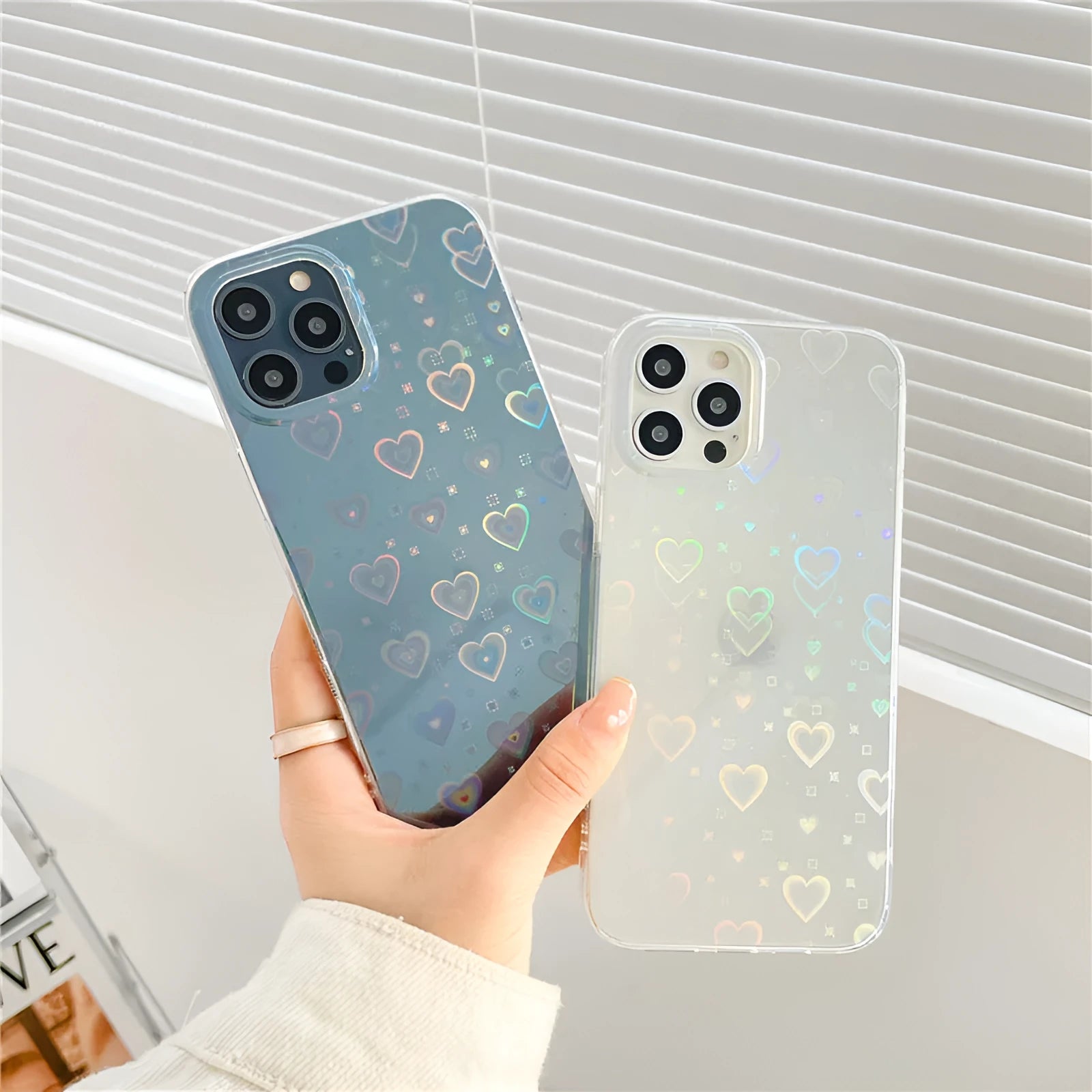 Transparent silicone iPhone case with a laser colourful love design shown on a phone.