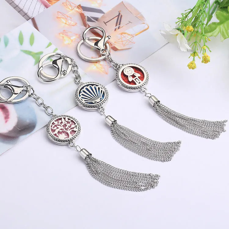 Tassel aromatherapy car pendant with alloy chain hanging from a rear-view mirror.
